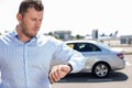 Attractive young man is checking time in the Royalty Free Stock Photo