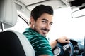 Attractive  man driving luxury car, view from backseat Royalty Free Stock Photo