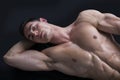 Attractive young man on the floor with muscular ripped body Royalty Free Stock Photo