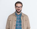 attractive young man with glasses wearing jacket, smiling and posing Royalty Free Stock Photo