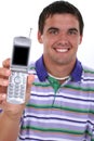 Attractive Young Man Holding Out Cellphone Royalty Free Stock Photo