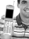Attractive Young Man Holding Out Cellphone in Black and White Royalty Free Stock Photo