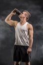 Attractive young man holding protein shake bottle