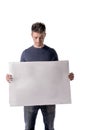 Attractive young man holding and showing blank white board Royalty Free Stock Photo