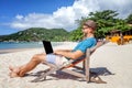 Attractive young man with laptop working on the beach. Freedom, Royalty Free Stock Photo