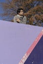 Attractive young man leaning on top of a wall with his arms crossed. Vertical orientation, Copy space Royalty Free Stock Photo