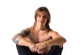 Attractive young man with long hair shirtless, sitting, isolated Royalty Free Stock Photo