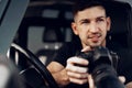 Attractive man photographer taking a photo while sitting in his car Royalty Free Stock Photo
