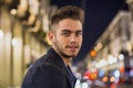 Attractive young man portrait at night with city lights