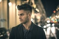 Attractive young man portrait at night with city lights