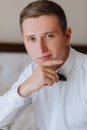 an attractive young man poses as a groom before a wedding. the groom is preparing for the wedding Royalty Free Stock Photo