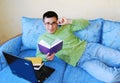 Attractive young man reading a book.