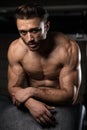 Attractive Young Man Resting In Gym Afther Exercise Royalty Free Stock Photo