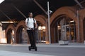 Attractive Young Man Riding Modern Kick Scooter At Cityscape Background. Royalty Free Stock Photo