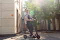 Attractive Young Man Riding Modern Kick Scooter At Cityscape Background. Contemporary Eco Transport Royalty Free Stock Photo