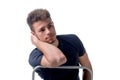 Attractive young man sitting, leaning on back of a chair Royalty Free Stock Photo