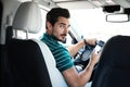 Attractive young man with  driving luxury car, view from backseat Royalty Free Stock Photo