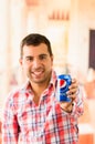 Attractive young man smiling holding a Pepsi Cola