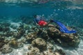 attractive young man snorkels in the ocean and observes the coral world, free diver in the sea, coral reefs in the Maldives Royalty Free Stock Photo