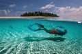 attractive young man snorkels in the ocean and observes the coral world, free diver in the sea, coral reefs in the Maldives Royalty Free Stock Photo