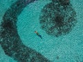 attractive young man snorkels in the ocean and observes the coral world, free diver in the sea, coral reefs in the Maldives Royalty Free Stock Photo