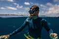 attractive young man snorkels in the ocean and observes the coral world, free diver in the sea, coral reefs in the Maldives Royalty Free Stock Photo