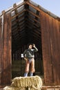 Attractive Young Man Standing on a Bale of Hay Royalty Free Stock Photo