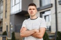 Attractive young man is standing on the street with a phone in his hands. Business handsome guy with a stylish hairstyle Royalty Free Stock Photo