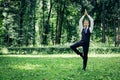 Attractive young man in a suit does yoga tree pose Royalty Free Stock Photo