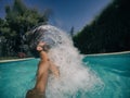 Attractive young man in swimming pool, hair movement backwards Royalty Free Stock Photo