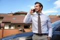 Attractive young man  on phone near luxury car outdoors Royalty Free Stock Photo