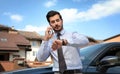 Attractive young man talking on phone near luxury car Royalty Free Stock Photo