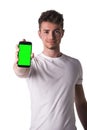 Attractive young man or teenager showing cell phone's screen Royalty Free Stock Photo