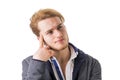 Attractive young man thinking, looking up with hand on his chin Royalty Free Stock Photo