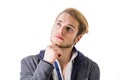 Attractive young man thinking, looking up unsure Royalty Free Stock Photo