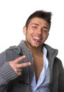 Attractive young man with tongue piercing, doing victory sign