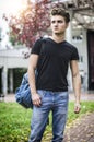 Attractive young man with backpack standing outdoor Royalty Free Stock Photo