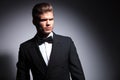 Attractive young man wearing elegant black suit and bow tie Royalty Free Stock Photo