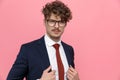 Attractive young man wearing glasses and adjusting suit Royalty Free Stock Photo