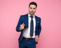 Attractive young man wearing navy blue suit on pink background Royalty Free Stock Photo