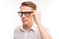 Attractive young man in white shirt touching his glasses Royalty Free Stock Photo