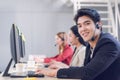 Attractive young man working in a call center with his colleagues Royalty Free Stock Photo