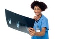 Attractive young medical professional holding x-ray sheet Royalty Free Stock Photo