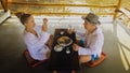 Man and woman eat and drink tasty beverages spending time in traditional local floating cafe on water. Loving happy