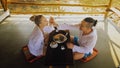 Man and woman eat and drink tasty beverages spending time in traditional local floating cafe on water. Loving happy