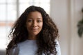 Attractive young mixed race black woman posing at home, portrait