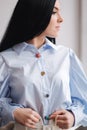 Attractive young model demonstrating clothes. Spring colections on elegant brunette woman. Blue shirt