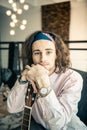 Attractive young musician wearing light shirt and colorful bandana