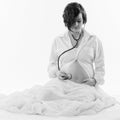 Attractive young pregnant woman with naked belly listening to her baby`s heartbeat with a stethoscope Royalty Free Stock Photo