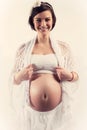 Attractive young pregnant woman with naked belly on white background smilling Royalty Free Stock Photo